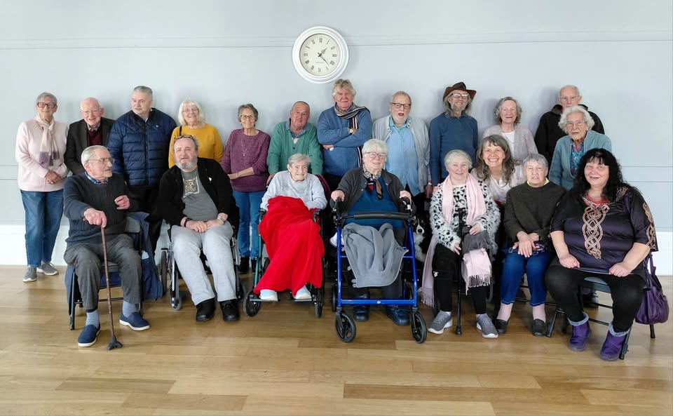 A group of elderly people smiling at the camera